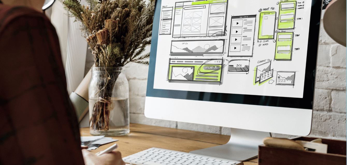 Designer working on a custom direct booking website layout for short-term rentals, enhancing brand identity and maximizing direct reservations with WaveBNB Website wireframe on screen representing Airbnb direct booking site design