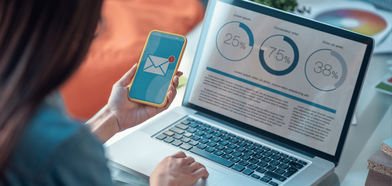 A marketing professional analyzing email campaign performance on a laptop while receiving a new message, representing WaveBNB’s automated email marketing for guest retention and booking Person checking Airbnb email automation results on phone and laptop analytics dashboard