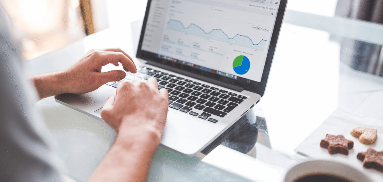 wavebnb-airbnb-analytics-dashboard-on-laptop-digital-marketing-data-review-performance-tracking Hands analyzing ad performance charts on laptop for Airbnb multi-channel campaigns