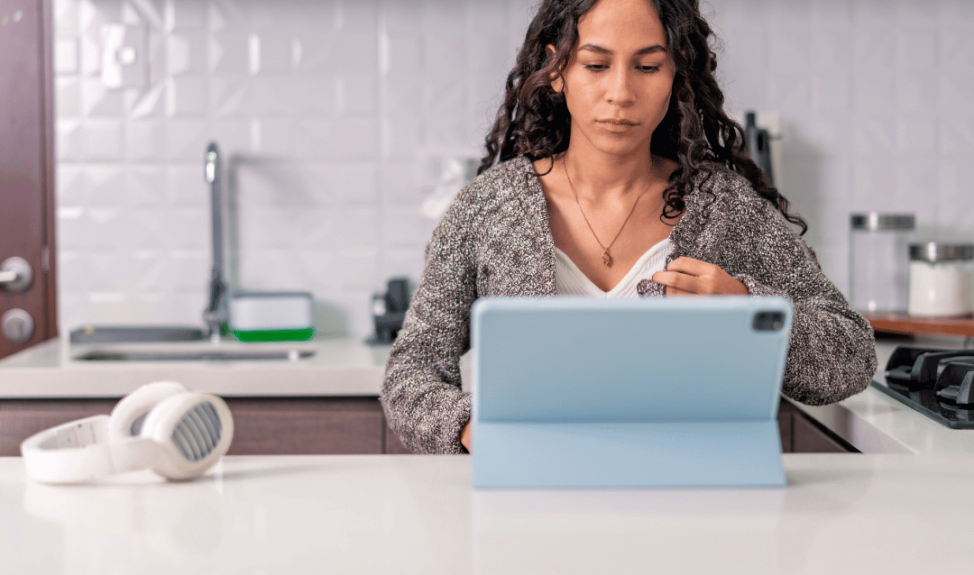 Airbnb host using WaveBNB automation tools on a tablet in kitchen